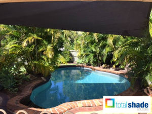 Shade sail over a pool sun protection summer hot uv keeping cool black charcoal outdoor space total shade solutions brisbane brendale